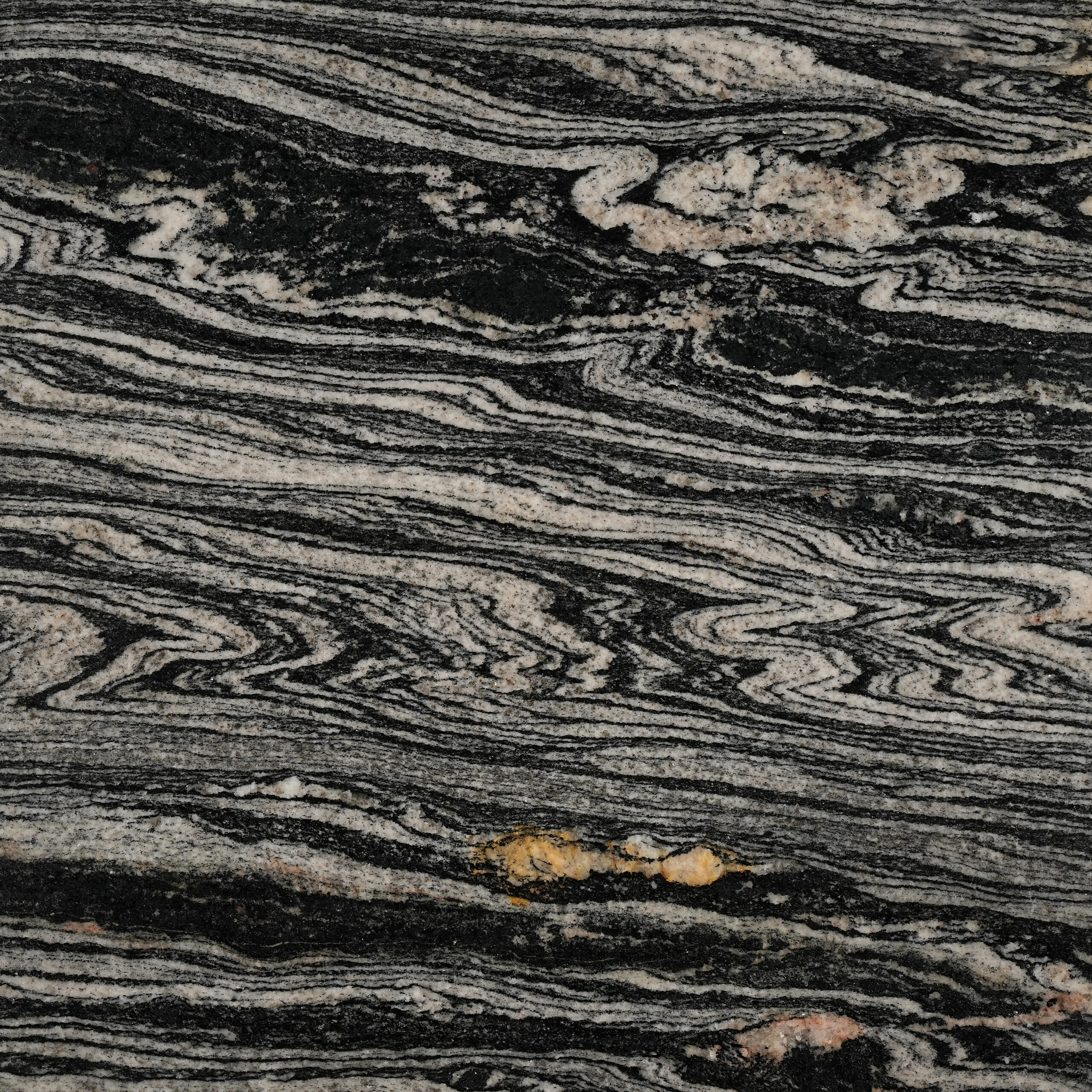 Exotic Gold granite nền đen, vân kem uốn lượn như sóng gỗ, điểm vàng hổ phách. Độc bản cho mặt bếp, quầy bar, ốp tường. Xem tại Vistones.