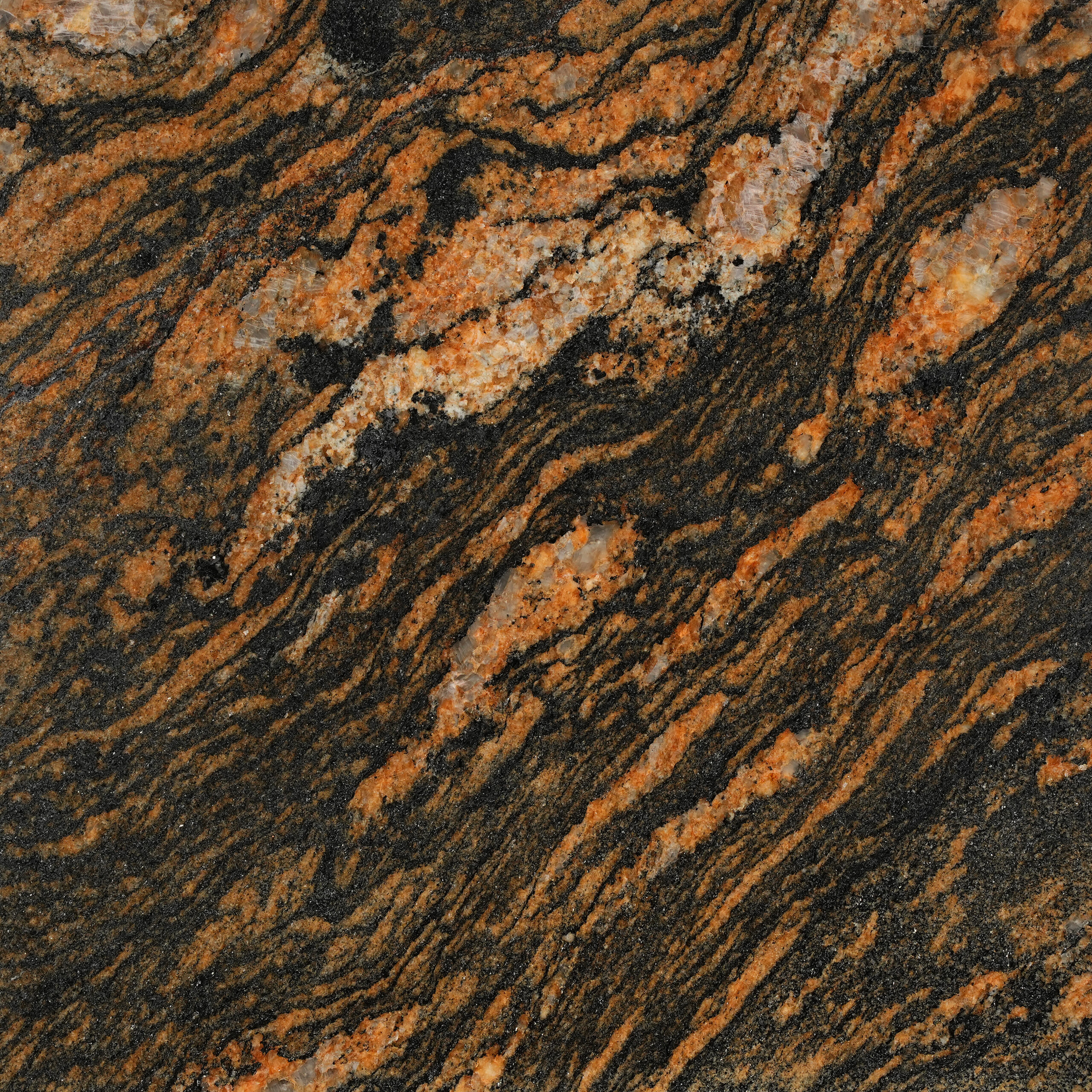 Fusion Gold granite dải cam đồng cuộn xoáy trên nền đen, tinh thể kem lấp lánh. Táo bạo cho mặt bếp, quầy bar, ốp tường. Liên hệ Vistones.