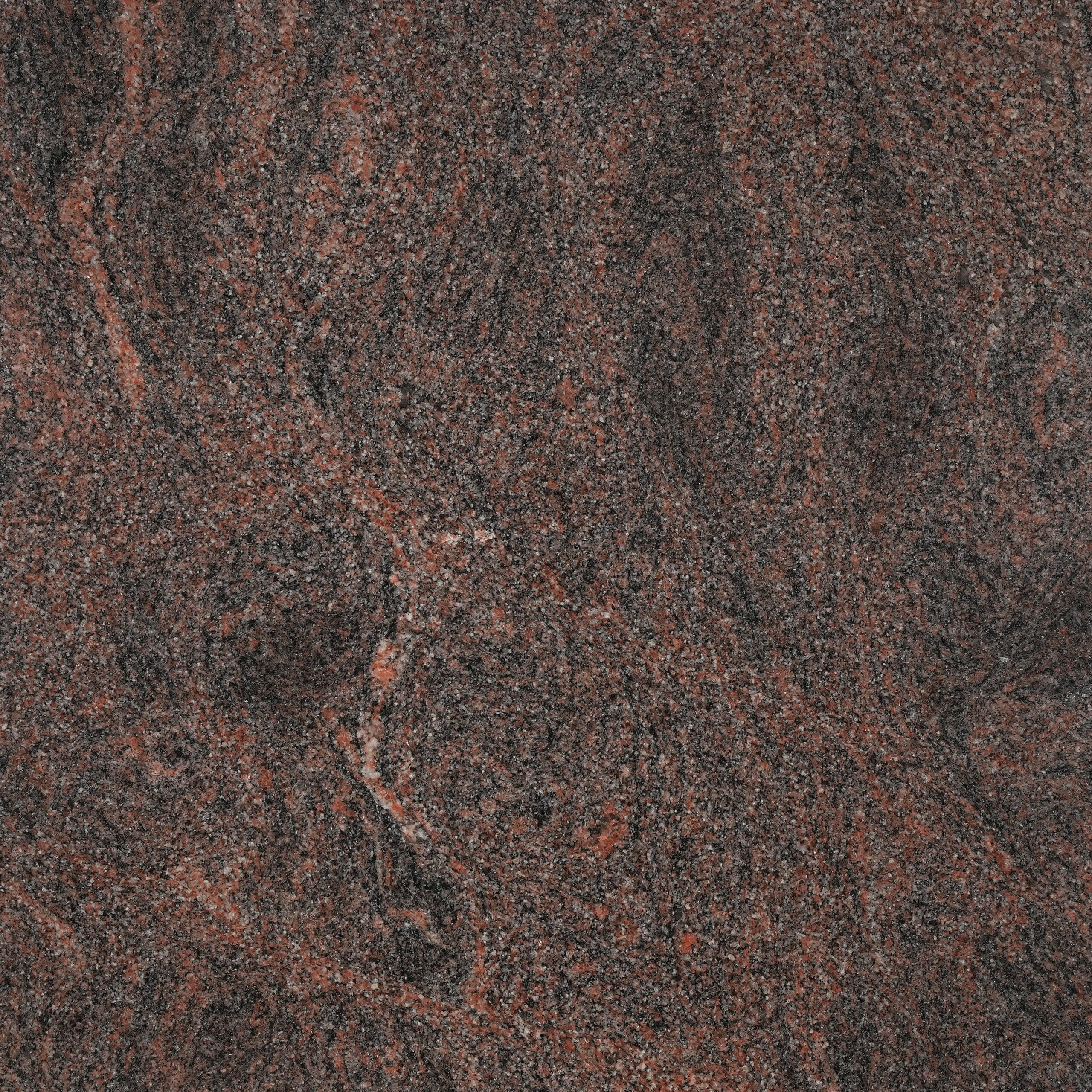 Himalayan Blue granite nền nâu đỏ sẫm, vân xoáy xám than đầy chuyển động. Bề thế cho mặt bếp, ốp tường, lát sàn. Xem mẫu tại Vistones Global.